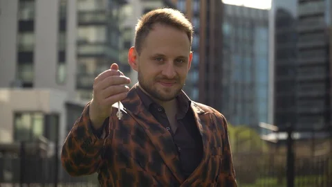 Young man real estate agent hands the keys to the apartment to the future owner. Stock Footage 130141108