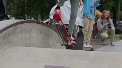 A young man in red shoes doing boardslide trick on a ledge in a skate park Stock Footage 63505254