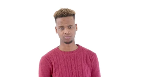 Young man in red sweater expressing confusion against white background Stock Footage 346597538
