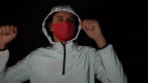 Young man in reflective jacket and medical mask having fun and dancing to the Stock Footage 150787650