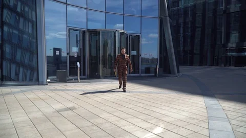 Young man rejoices in the invitation to work near the office building. Stock Footage 130139128