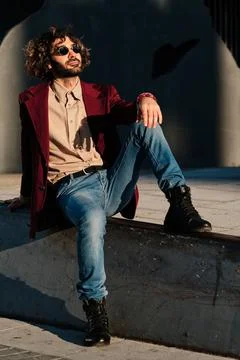 Young man relaxed while sitting outdoors. Stock Photos