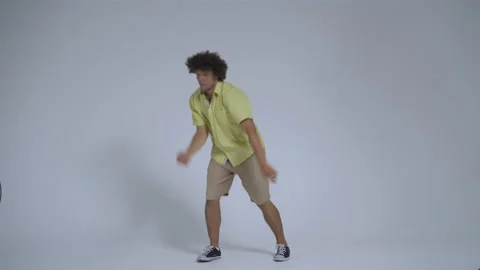 Young man relaxedly dancing in the studio against an isolated background. Guy Stock Footage 139813611