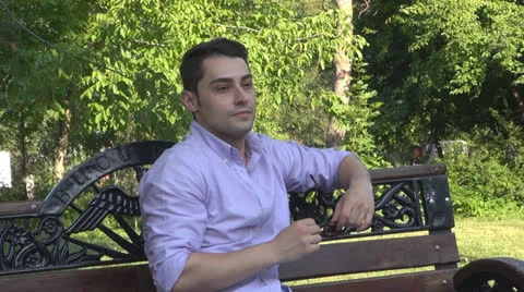 Young man  is relaxes in the park Vídeos de archivo 25552050