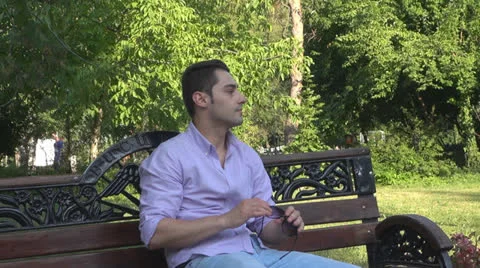 Young man  is relaxes in the park 스톡 동영상 25552204