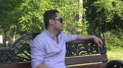 Young man  is relaxes in the park Vídeos de archivo 25553517