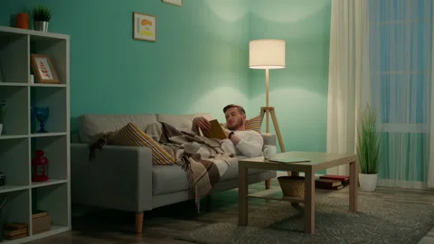 Young Man Is Relaxing With Book Video stock 170481559