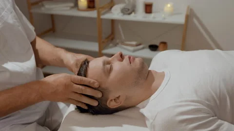 Young man relaxing during professional head massage in SPA salon. Manual Stock Footage 170516211