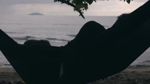 Young man relaxing in hammock on beach in Rincon Puerto Rico Stock Footage 157567765