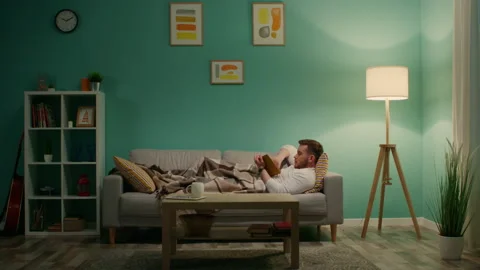 Young Man Is Relaxing On Sofa Video stock 161317728