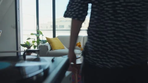 Young man relaxing on sofa using smartphone in modern apartment Stock Footage 306582553