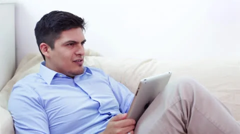 Young Man Relaxing with Tablet Computer Stock Footage 27212248