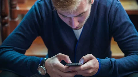 Young Man Relaxing Using Cell Phone Stock Footage 32724426
