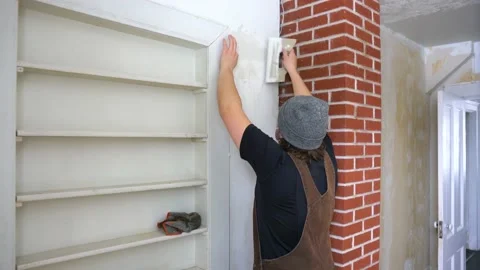 A young man renovating a room in an old house. Video stock 150056909