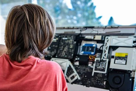 Young man repairing broken computer Rear view of male computer engineer di... 写真素材