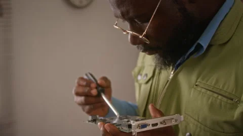 Young Man Repairing Computer Graphics Card with Screwdriver Stock Footage 341426396