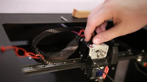 Young man repairs 3D printer repairs the details of debugging work. Stock-Footage 124384715