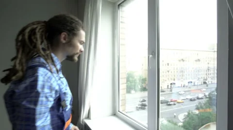 A young man is repearing the window Stock Footage 65287924