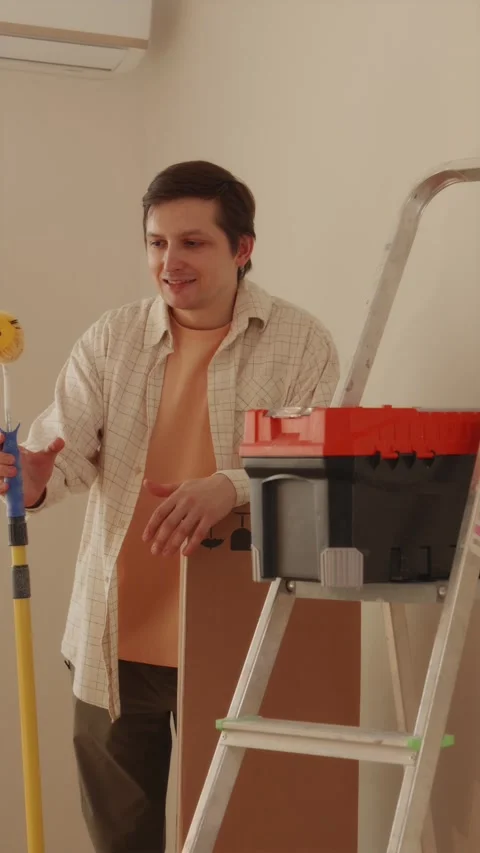 Young man resting after completing room renovation work Video stock 346396604