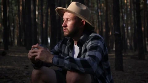 Young man resting and drinking hot tea while hiking in the mountains Stock Footage 150256058