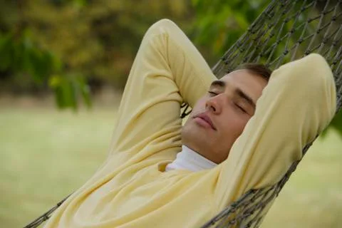 Young man resting in hammock Stock Photos