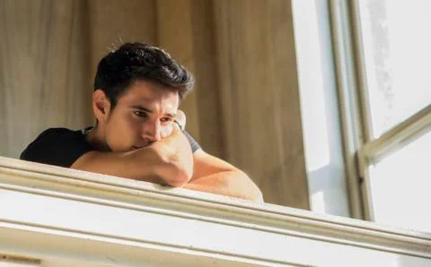 Young Man Resting with Head on Staircase Railing Stock Photos