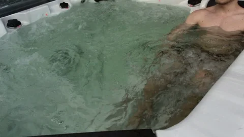 Young Man Resting In The Jacuzzi under open air Stock Footage 108432821