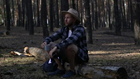 Young man resting, looking through binoculars and checking a map while hiking Stock Footage 150255796