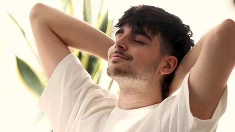 Young man resting relaxed smiling with pleasure Stock Footage 254013502