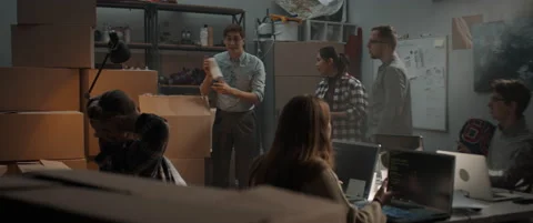 Young man reveals the first samples of product being developed by a startup team Stock Footage 145534591