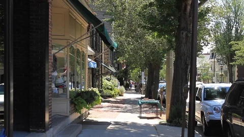 A young man ride a bicycle down a street in a quiet town Stock Footage 113751942