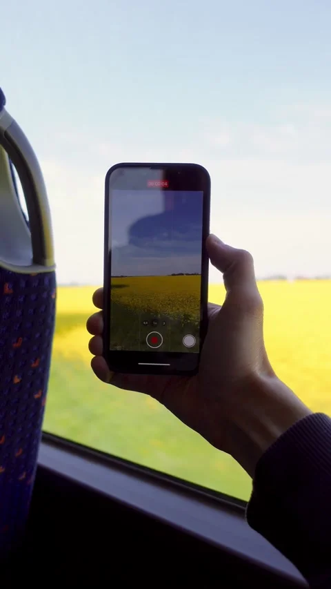 A young man rides a bus and shoots beautiful landscapes of nature on his phone Stock Footage 240241925