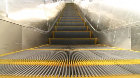 Young man rides escalator Stock Footage 23426048