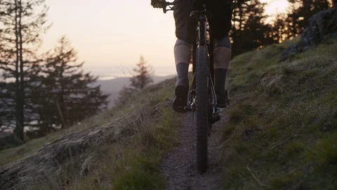 Young man rides his mountain bike into the sunset - Orcas Island Stock Footage 89021561