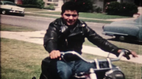 Young man rides his new motorcycle around the yard at home 7979 Stock Footage 317336132