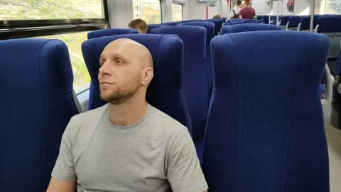 Young man rides a train and looks out the window Video stock 201167304