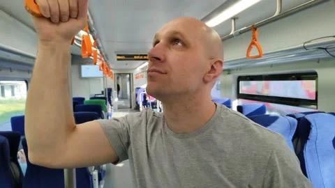 Young man rides train and looks around Видео 201167305