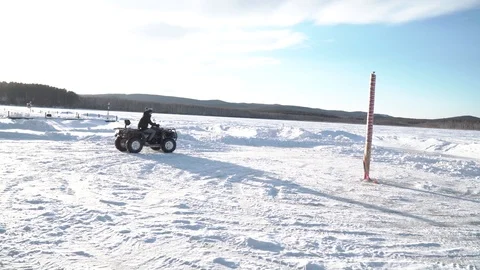 A young man riding an ATV in winter Stock Footage 87470973