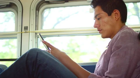 A young man riding a bus and using a tablet Stock Footage 57628014