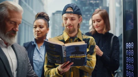 Young Man Riding Elevator Reading Book 스톡 동영상 167836723