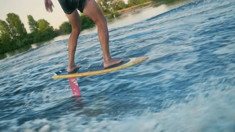 Young man riding a foil surf, breaking the ocean waves.Foil Surfing in slow Stock Footage 201518864