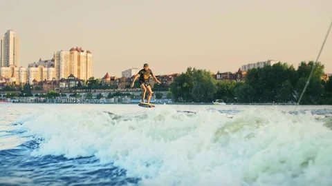 Young man riding a foil surf, breaking the ocean waves.Foil Surfing  Stock Footage 201518873