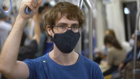 Young Man Riding Inside Subway Train With Face Mask During Coronavirus Pandemic Stock Footage 133018908