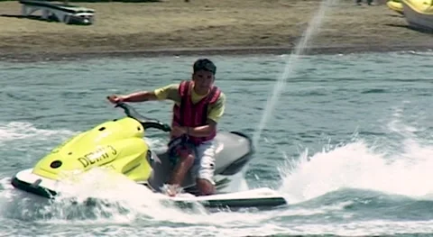 Young man is riding jet ski. "Bay Beach Club" Hotel. Turkey, Fethiye, 2009. Stock Footage 160045726