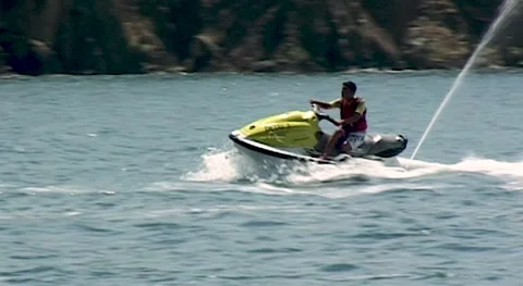 Young man is riding jet ski. "Bay Beach Club" Hotel. Turkey, Fethiye, 2009. Stock Footage 160045771