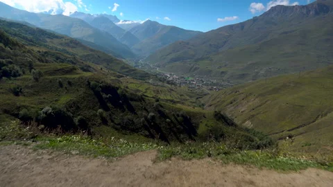 A young man is riding a swing in the mountains. First-person view of the Stock Footage 139742950