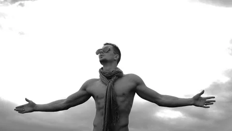 Young man rises hands on sky background Видео 90653151