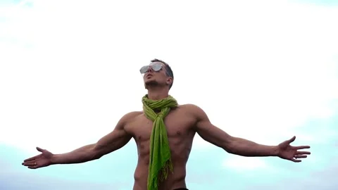 Young man rises hands on sky background Видео 90754711