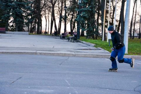 Young man roller skating in the central of the city. Stock-Fotos