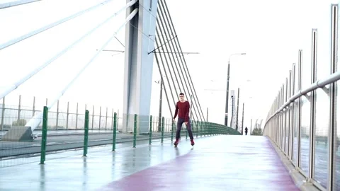 Young man in rollerblades doing spin in the city, super slow motion Stock Footage 96420146